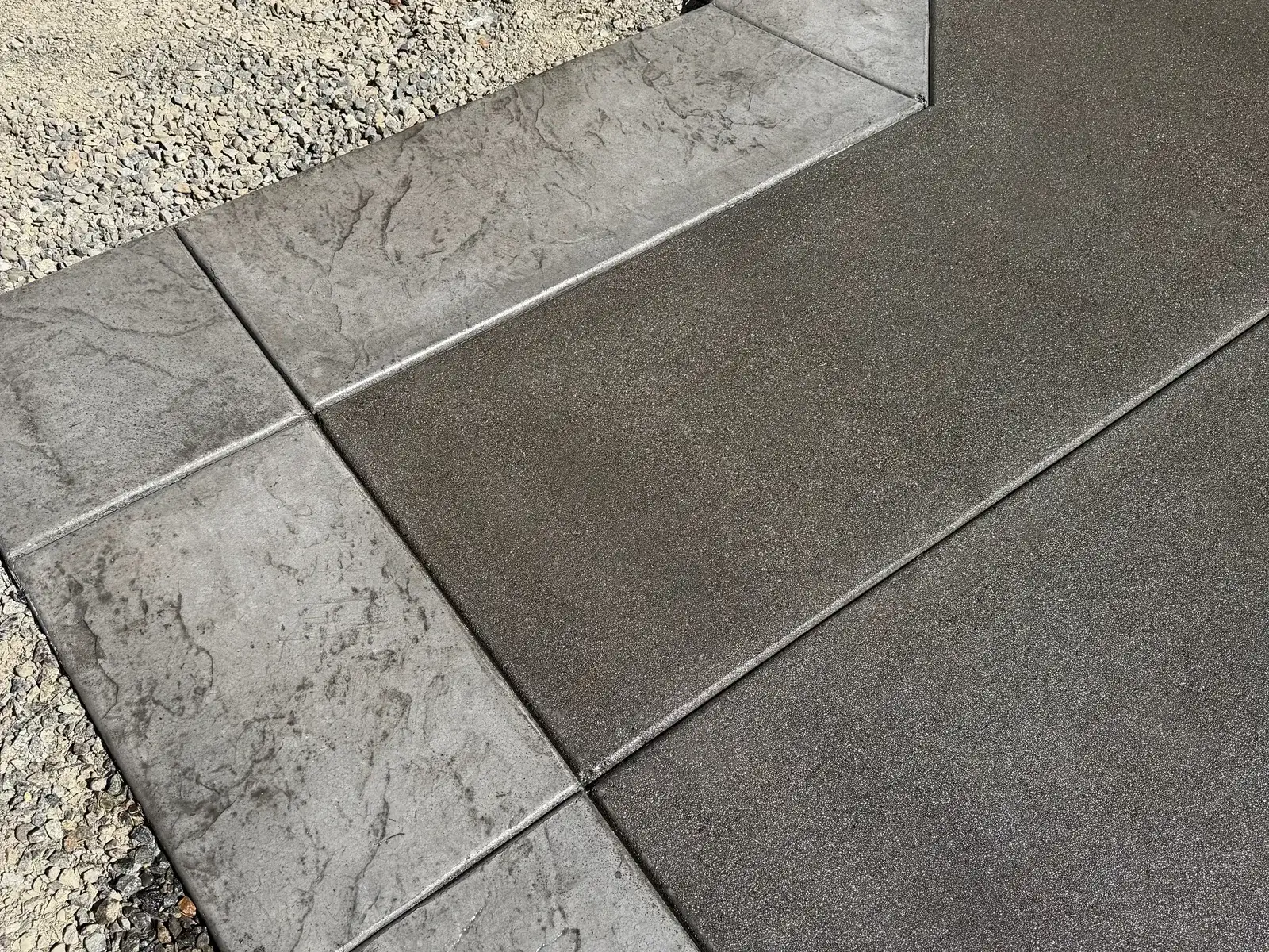 Charcoal concrete patio with a stamped border