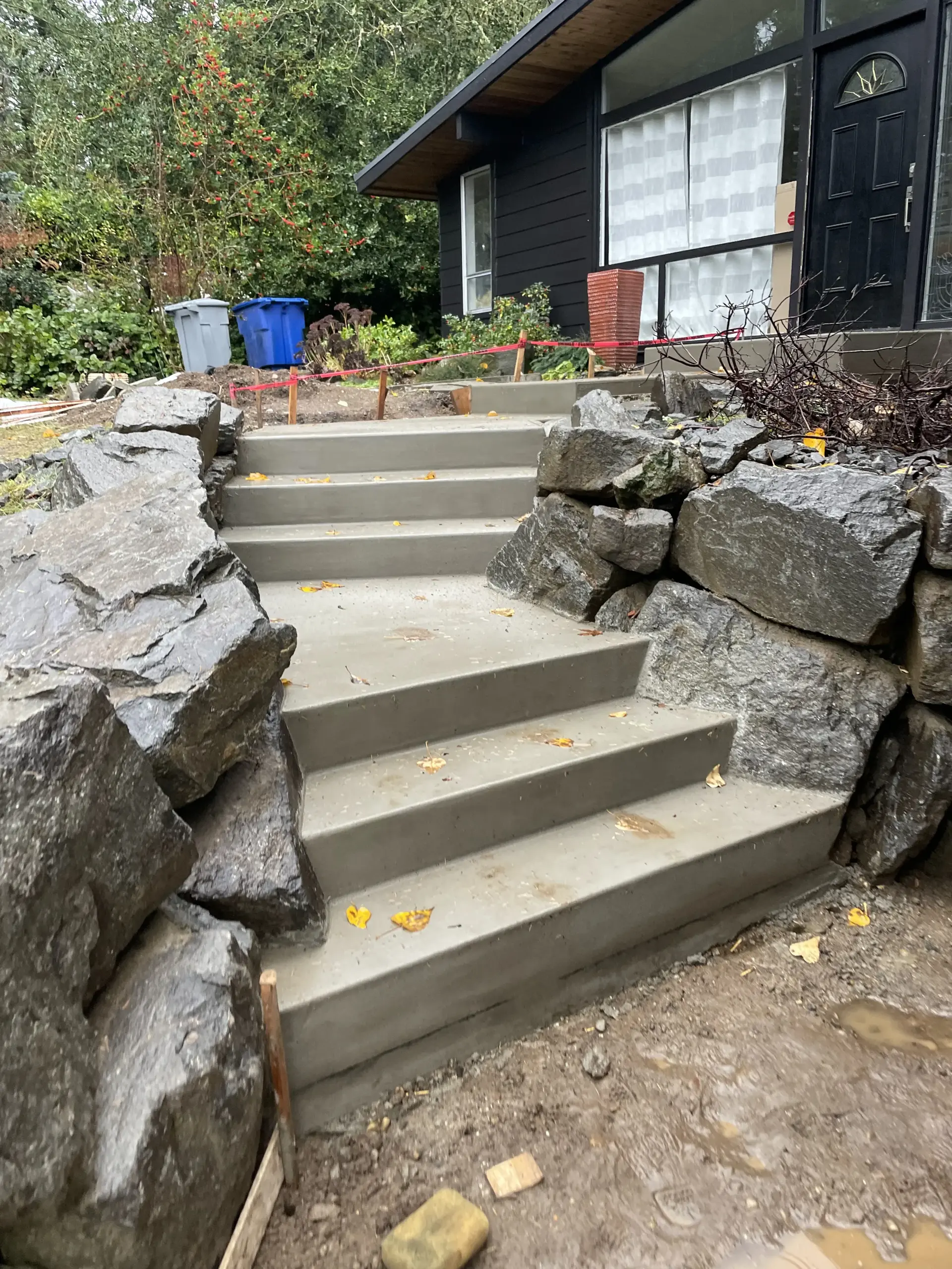 Concrete entry stairs with natural rock walls