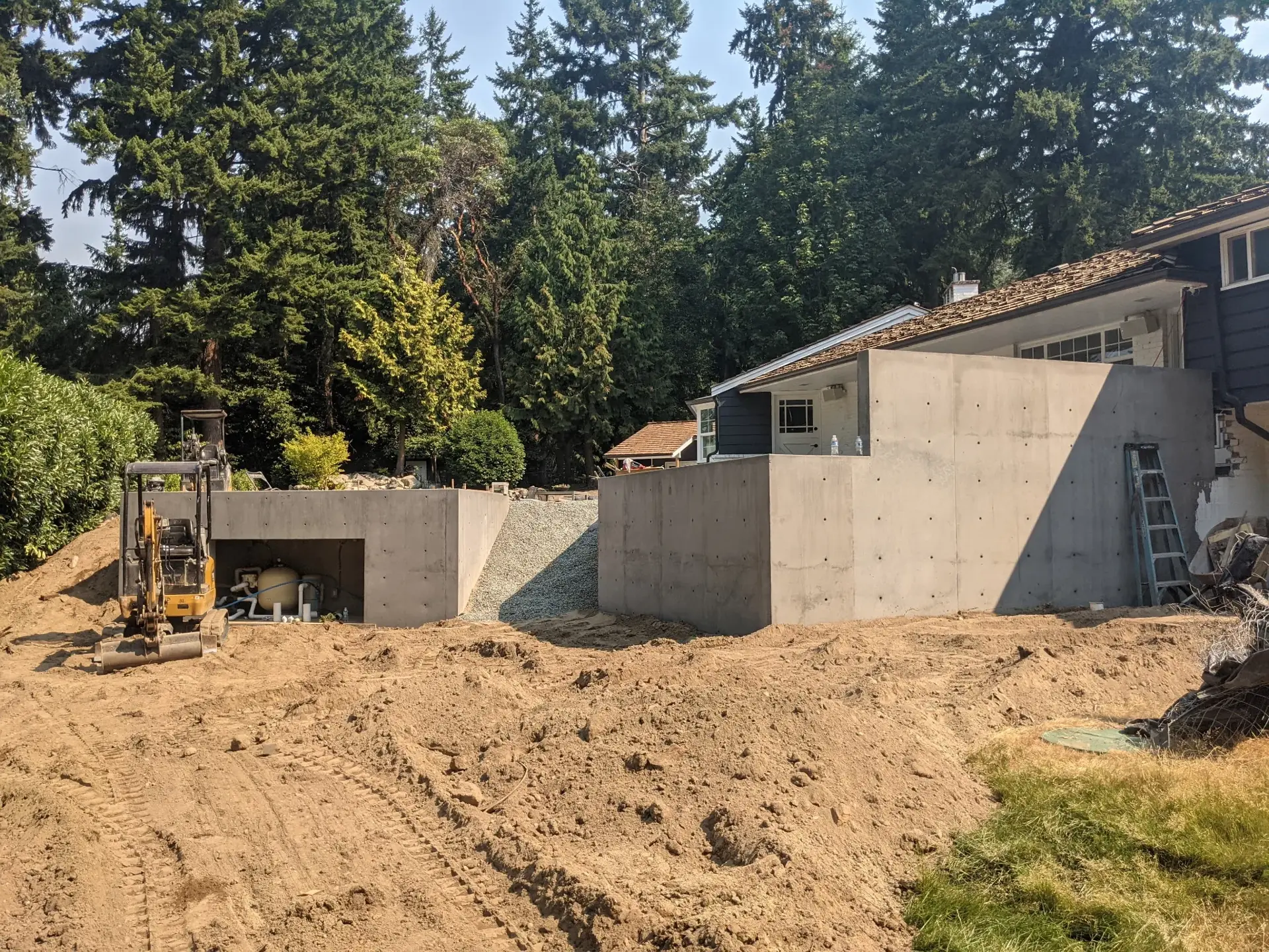 Finished smooth concrete foundation and tiered retaining walls — HTS Concrete & Construction