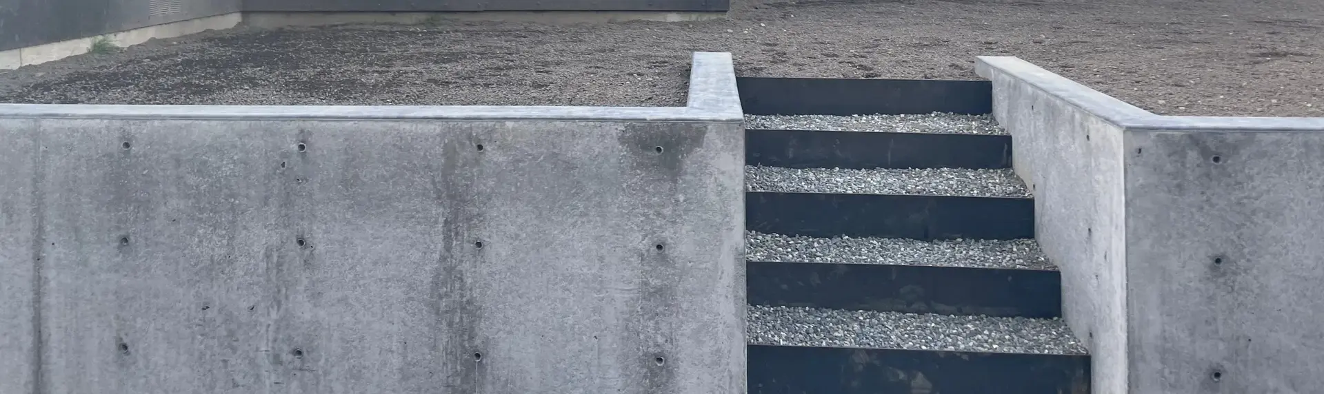 Poured concrete walls and entry stairs at a modern home