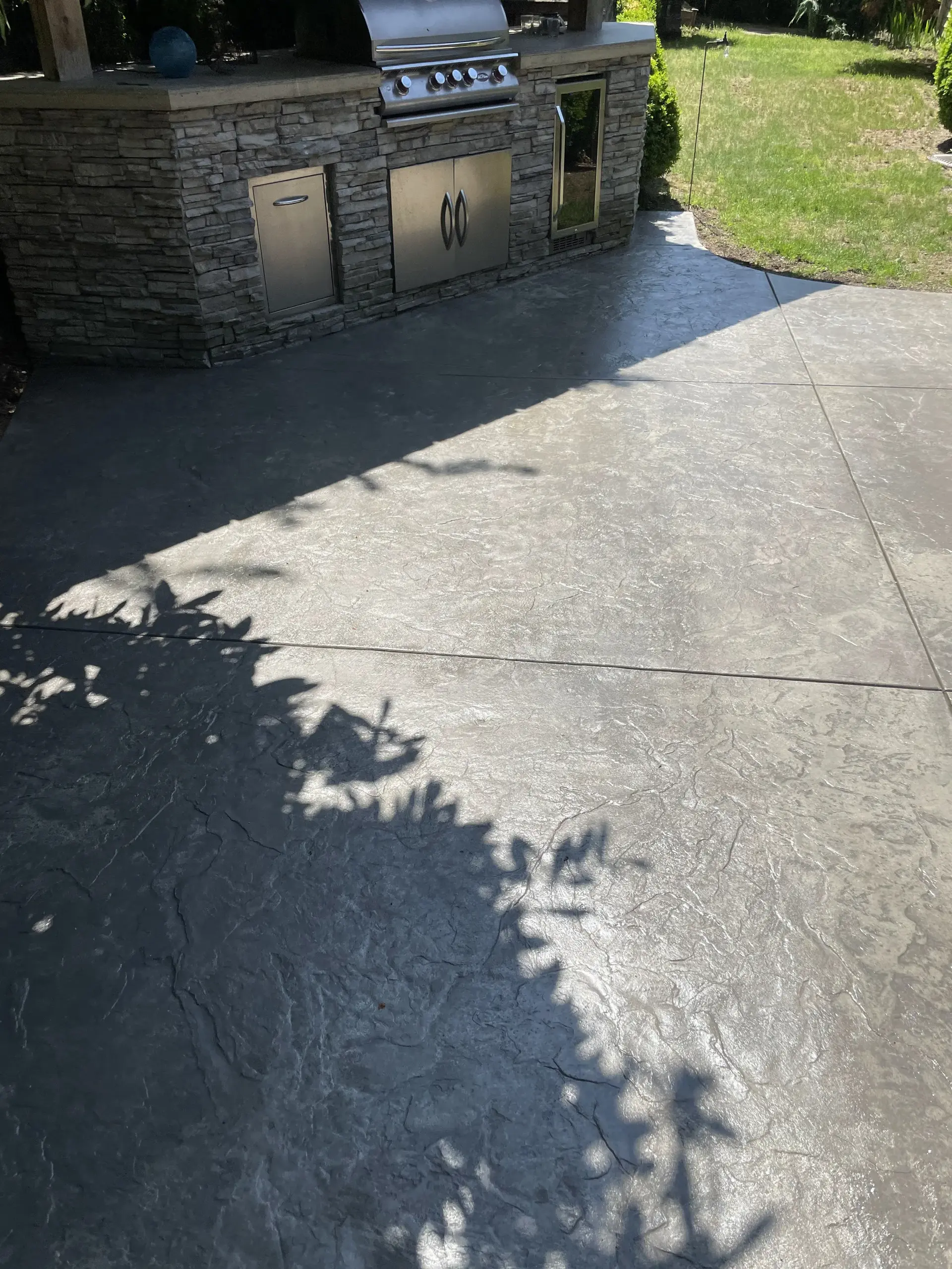 Stamped patio beside outdoor kitchen