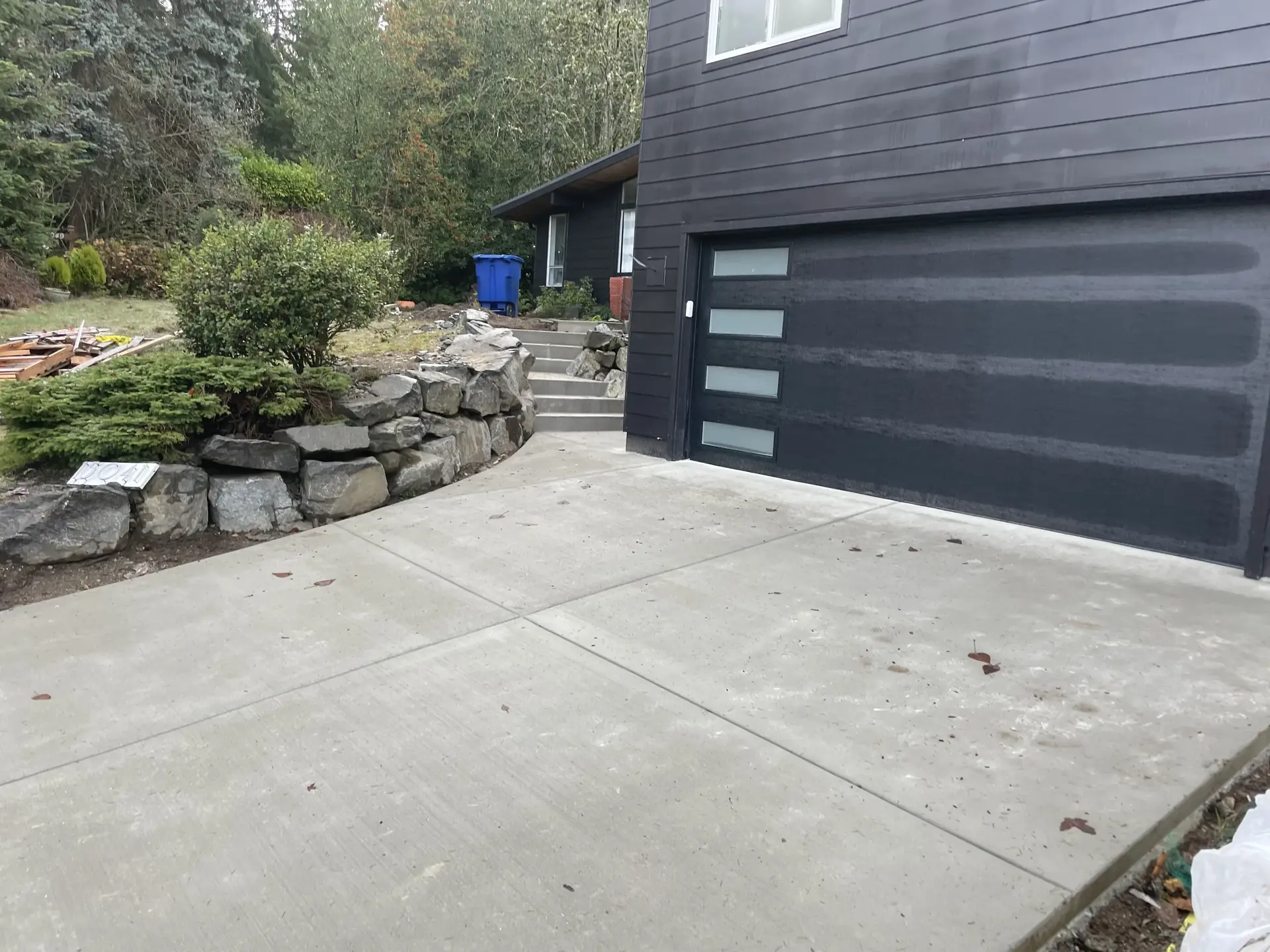 Residential driveway with rock retaining wall and steps